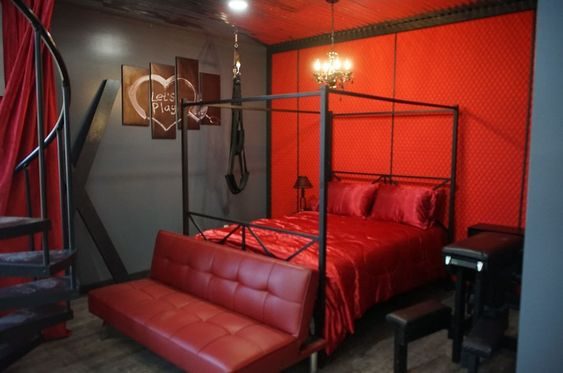 The Erotic Dungeon Bedroom — four-poster bed in crimson